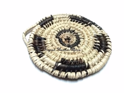 A handwoven black and white coaster