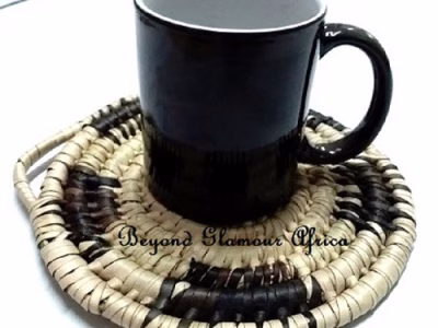 A handwoven black and white coaster