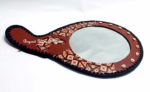A brown leather mirror very fashionable to have