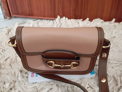 Leather brown sling bag.